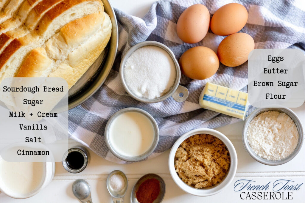 A table of ingredients for the recipe including a loaf of sliced bread, cream, milk, white and brown sugar, cinnamon, butter and eggs.